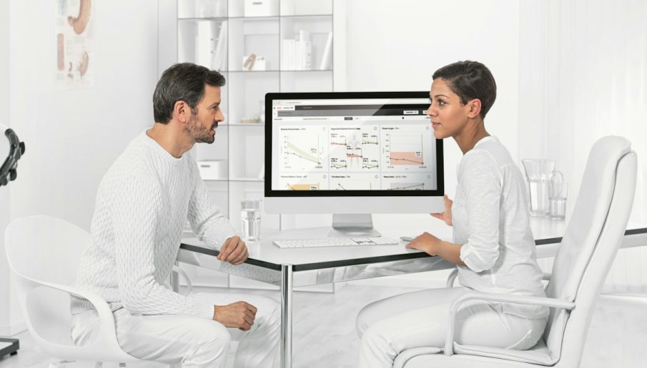 man in white dress shirt sitting on white chair in front of computer {{brizy_dc_image_alt imageSrc=